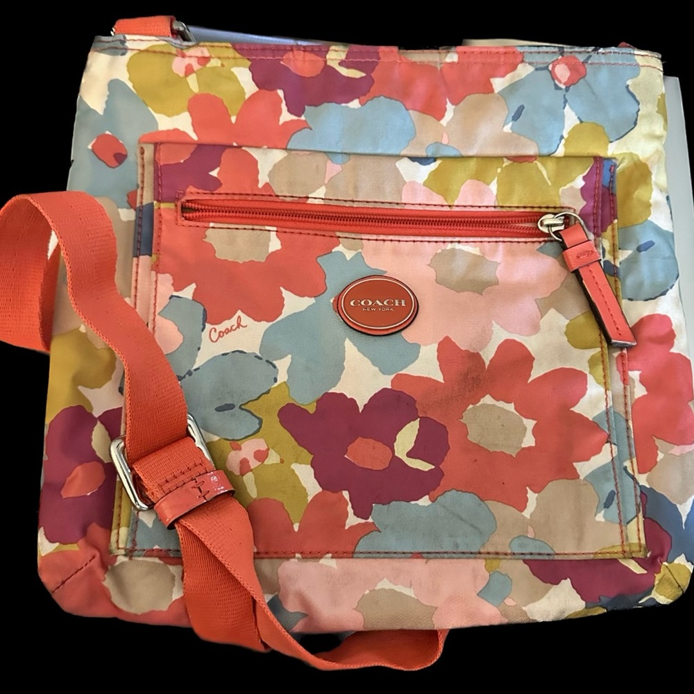 Coach crossbody .Floral print with orange, blues and greens.